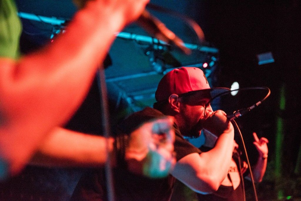 MC performing live with red and cyan stage lights